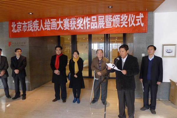 图为梁田巡视员在北京市残疾人绘画大赛获奖作品展上发言